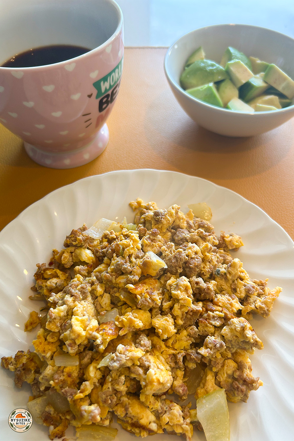 Low carb breakfast plate with scrambled eggs, ground beef, avocado and coffee