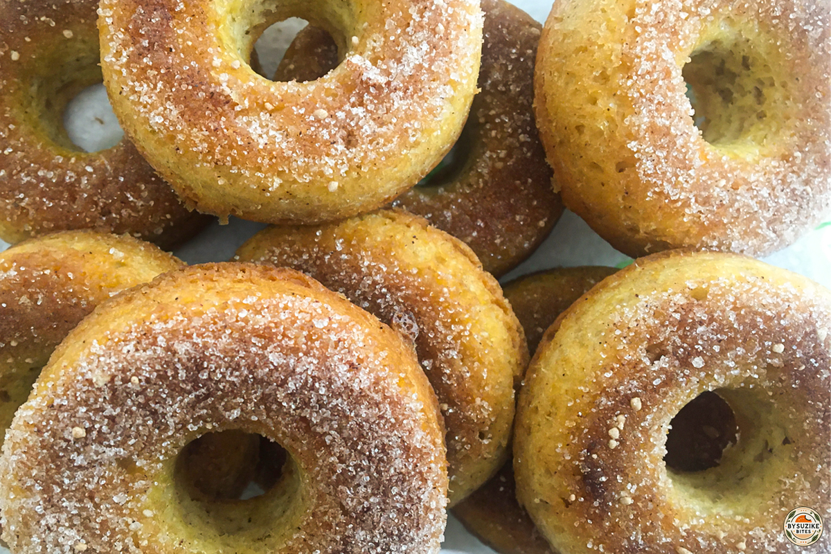 Close-up of keto cinnamon donuts with a golden brown finish, topped with sugar-free cinnamon coating.