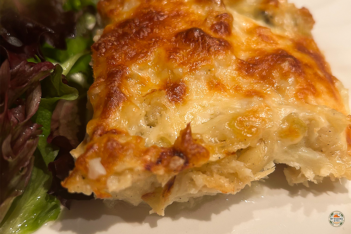 Golden slice of low carb Bacalhau com Natas served with green salad