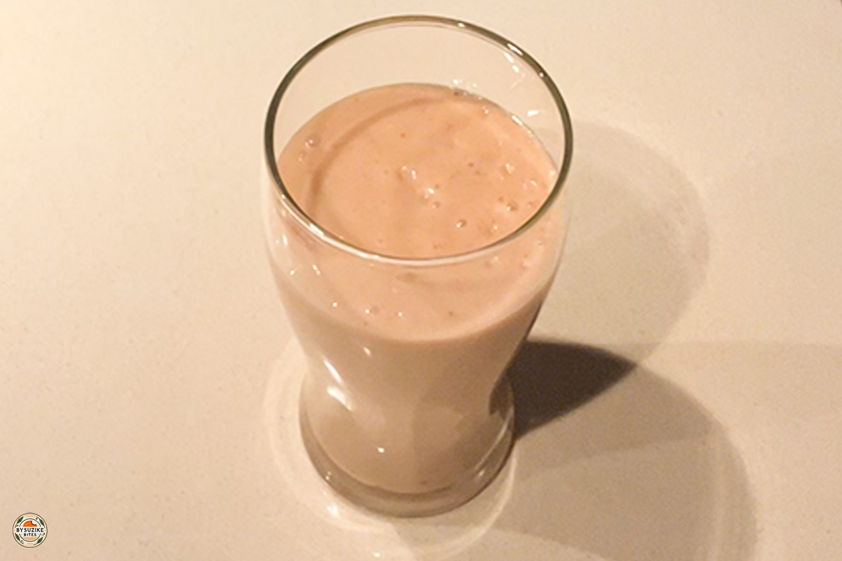 Strawberry smoothie 4 Glass of low carb strawberry avocado smoothie with a slice of strawberry on top