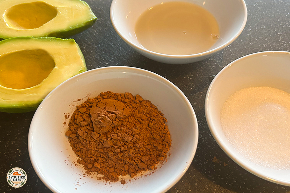 Avocado chocolate mousse in a white ramekin topped with sliced strawberries – healthy low carb dessert.