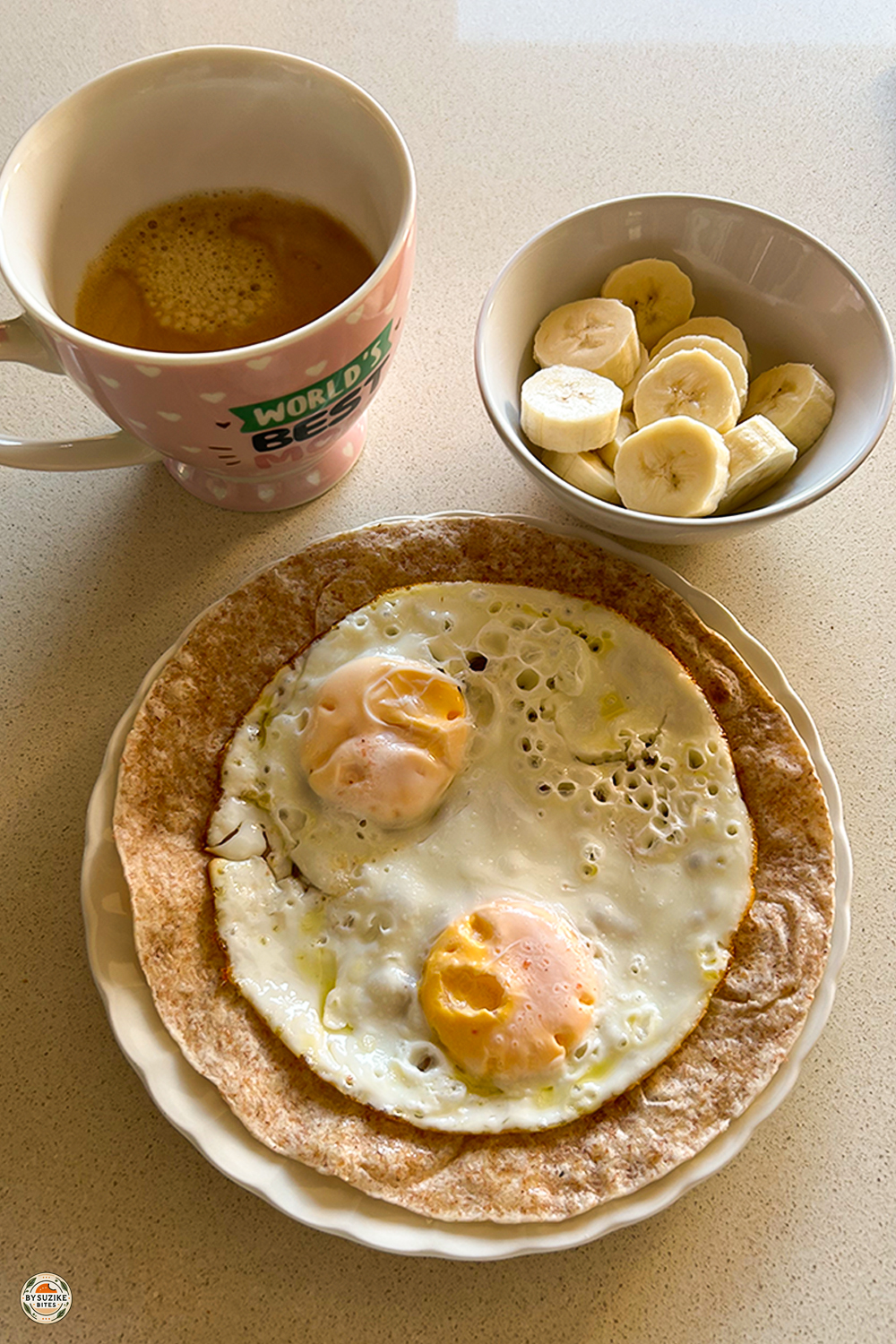 Egg wrap breakfast with fried eggs, sliced banana, and black coffee, an easy real-life breakfast idea.