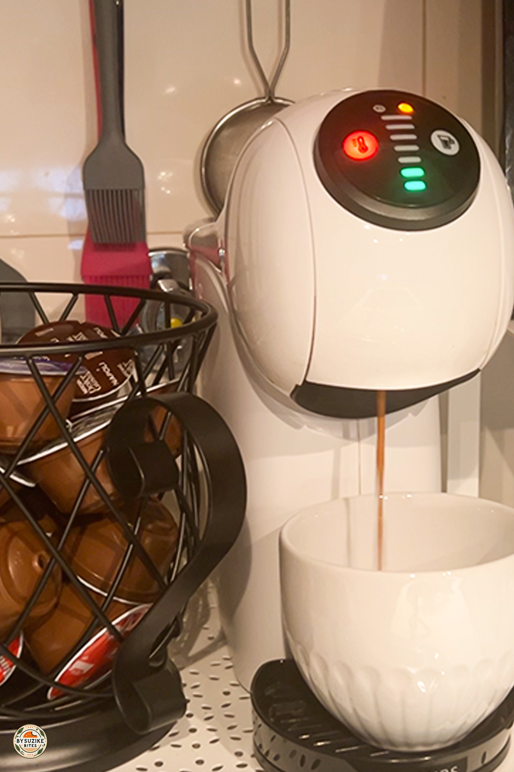 Dolce Gusto Genio S coffee machine in use on kitchen counter with capsules