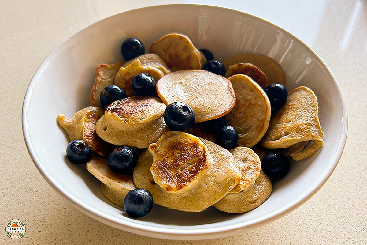 Mini oat and banana pancakes served in a bowl with fresh blueberries – healthy breakfast recipe for kids and adults
