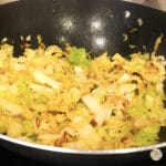 Keto Fried Cabbage and onion sautéing in butter in a wok