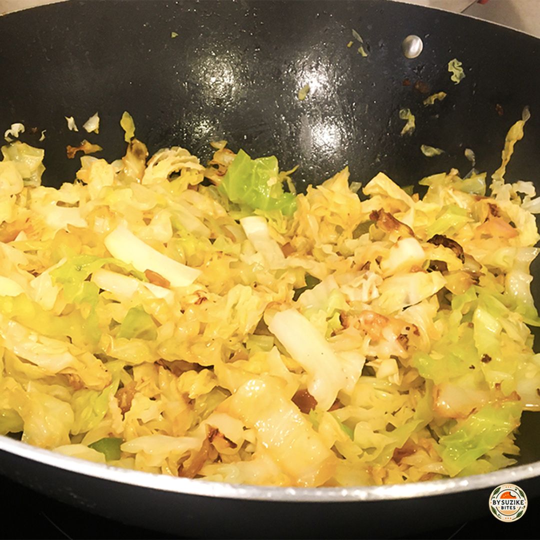 Keto Fried Cabbage and onion sautéing in butter in a wok