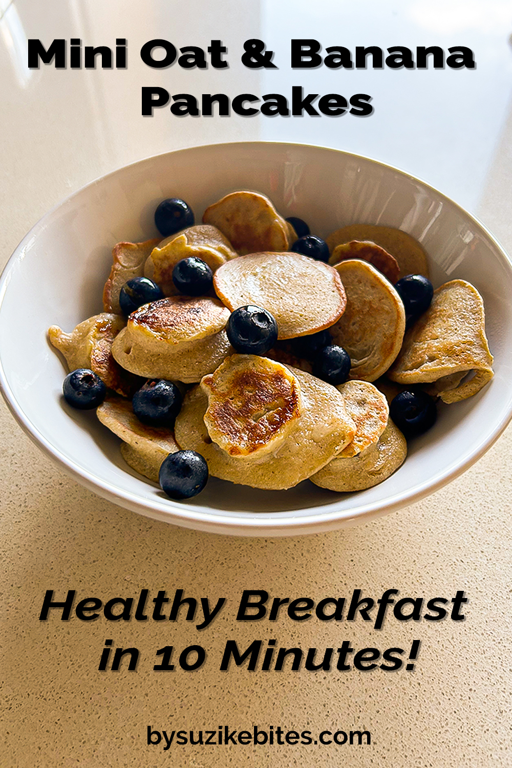 Bowl of mini oat and banana pancakes with blueberries – healthy breakfast idea for kids and adults