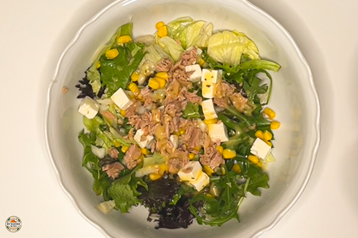 Close-up of creamy feta with crisp lettuce and corn for texture detail