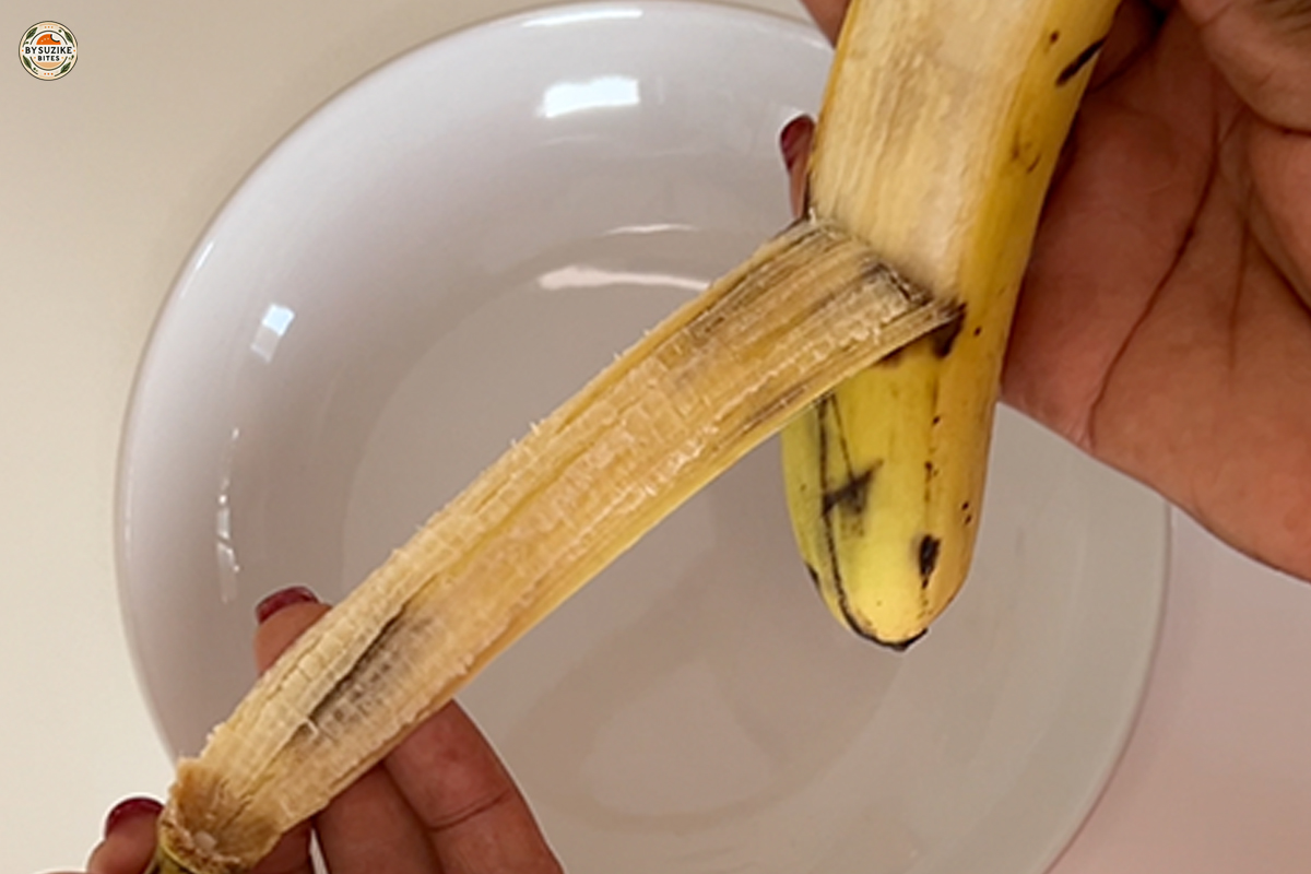 Oat Banana Cake 2 Peeling a ripe banana for homemade oat banana cake recipe