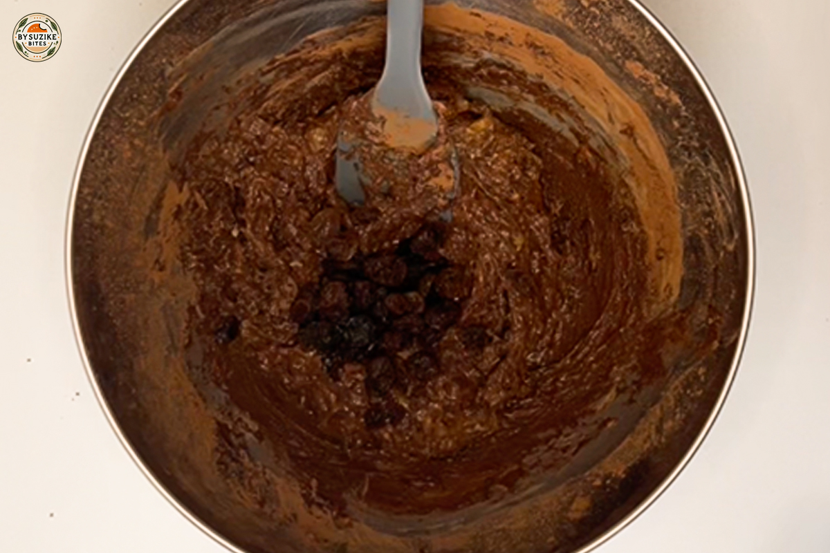 Folding raisins into vegan brownie batter