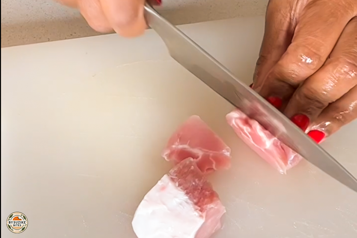 pork-with-okra-step-1-cutting-pork Step 1: Cutting fresh pork into small cubes for the okra stew