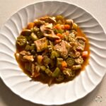 Pork and okra dish served with couscous thumbnail