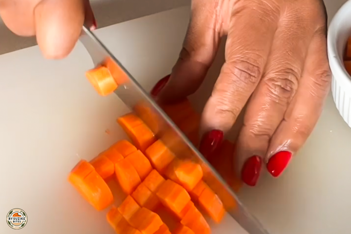 pork-with-okra-step-8-chopping-carrot Step 8: Cutting a carrot into small cubes for the stew
