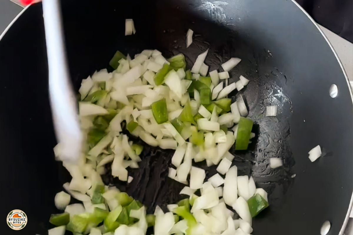 pork-with-okra-step-9-sauteing-onion-pepper Step 9: Sautéing chopped onion and green pepper in a pan