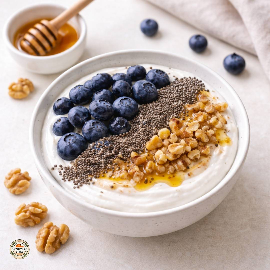 Greek yogurt bowl with blueberries, chia seeds, walnuts, and honey for a high protein high fiber breakfast