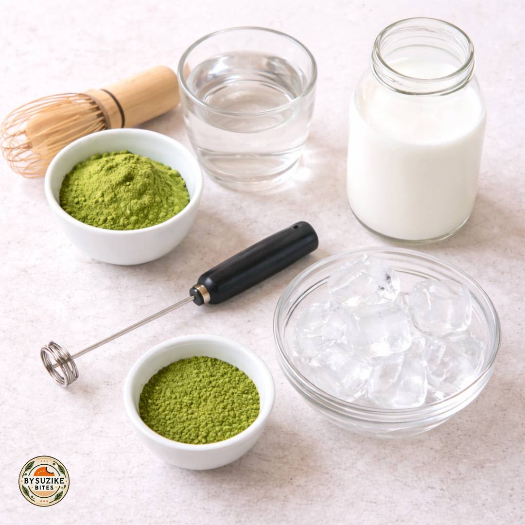 Iced matcha latte in a glass with ice on a bright neutral background