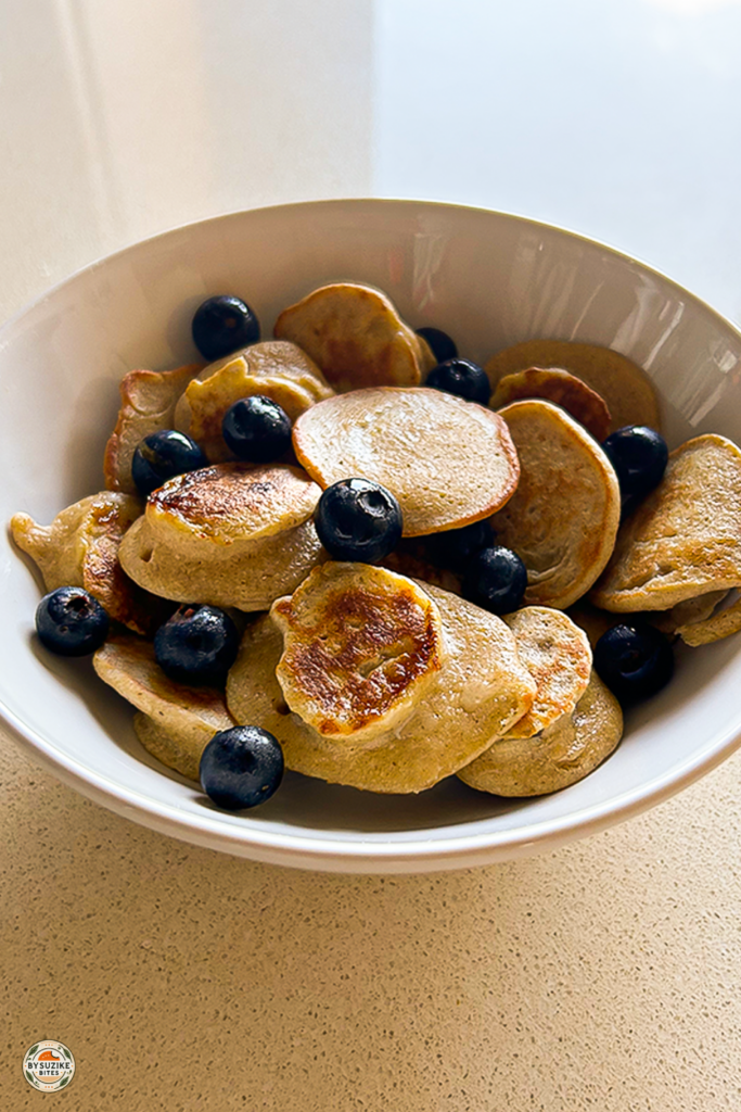 Mini oat and banana pancakes served in a bowl with fresh blueberries – healthy breakfast recipe for kids and adults
