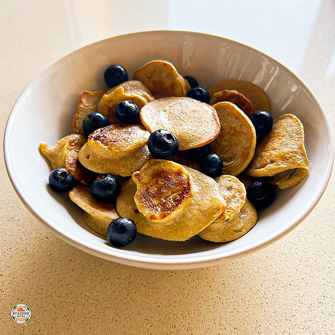 Mini oat and banana pancakes served in a bowl with fresh blueberries – healthy breakfast recipe for kids and adults