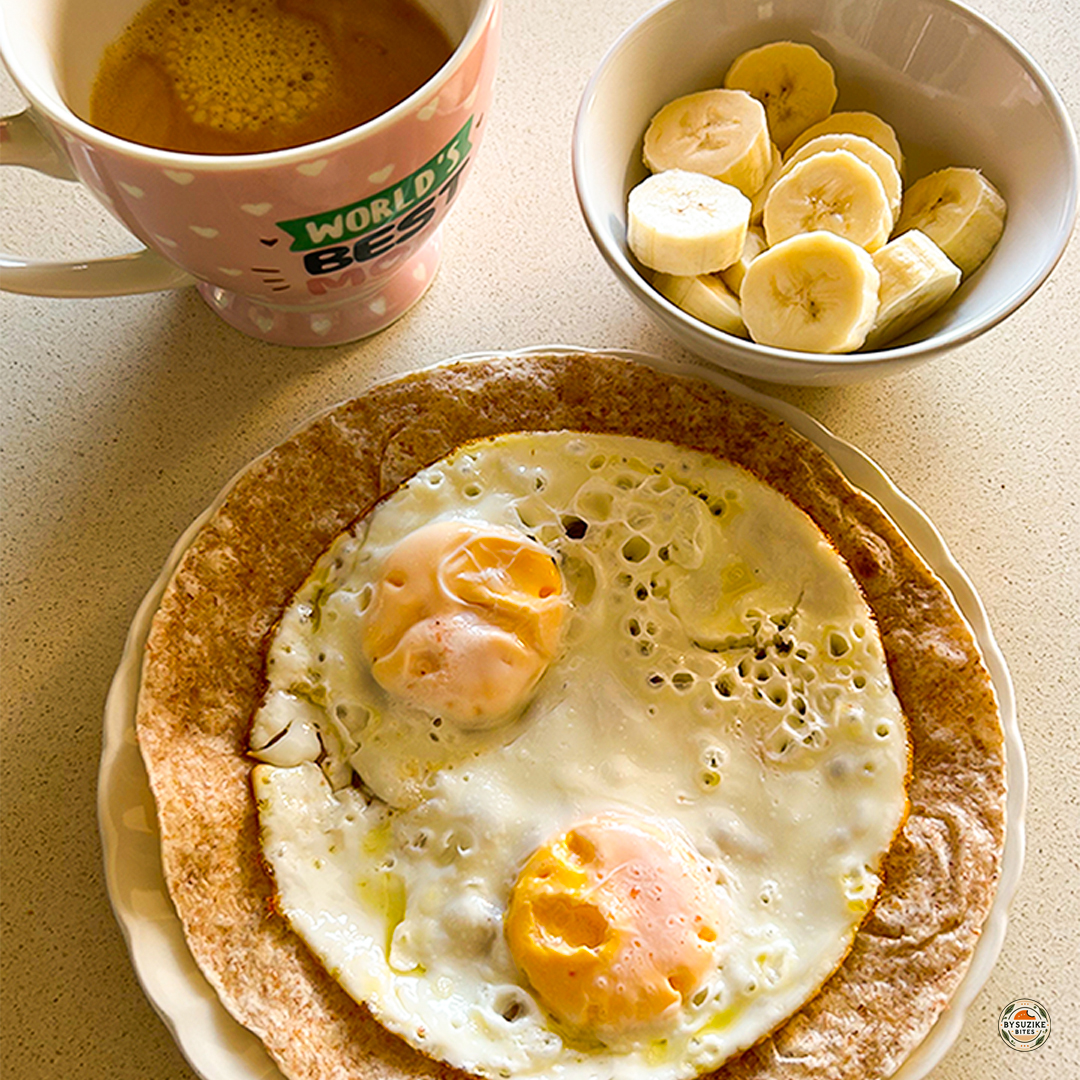 Easy breakfast ideas: Egg wrap breakfast with fried eggs, sliced banana, and black coffee, an easy real-life breakfast idea.